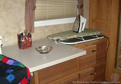 a kitchen counter with a sink, microwave and window in the backround area