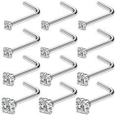 six pairs of stainless steel nose piercings with clear crystal stones