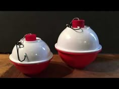 two white and red containers sitting on top of a wooden table