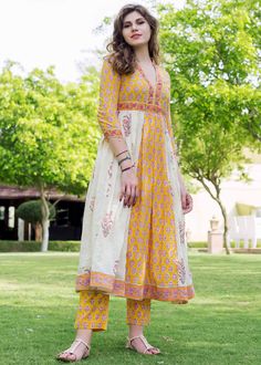 Yellow color cotton quarter sleeves flared long kurta adorn contrasting side panels and has been beautified with hand block printed floral motifs all over. The readymade ensemble includes a yellow block printed cotton pant. The maximum length kurta and pant are available in is 50 and 39 inches respectively. Do Note: All Accessories shown are for styling purpose only. Slight color variation may occur due to photographic reasons. Yellow Anarkali Set With Floral Print Straight Kurta, Yellow Floral Print Anarkali Set With Straight Kurta, Yellow Mulmul Palazzo Set With Printed Motifs, Yellow Printed Mulmul Palazzo Set, Bohemian Yellow Palazzo Set With Printed Motifs, Yellow Bohemian Palazzo Set With Printed Motifs, Yellow Bollywood Style Floral Kurta, Yellow Cotton Salwar Kameez With Floral Print, Yellow Anarkali Kurta With Floral Print