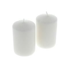 two white candles sitting next to each other