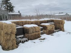 hay bales are stacked on top of each other in the snow