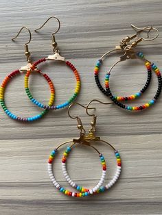 A little rainbow for you for Pride! Or just those who love all things rainbow. Seed beads on a wire hoop on a gold ear wire. These can also be done in silver. Just choose your finish when you check out. Everyday Rainbow Round Bead Jewelry, Everyday Rainbow Jewelry With Round Beads, Rainbow Hoop Earrings With Ear Wire As Gift, Rainbow Nickel-free Dangle Hoop Earrings, Nickel-free Rainbow Dangle Hoop Earrings, Nickel-free Small Hoop Rainbow Earrings, Nickel-free Multicolor Heishi Beads Jewelry, Adjustable Circular Beaded Earrings With Tiny Beads, Everyday Rainbow Beaded Jewelry