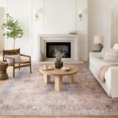 a living room filled with furniture and a fire place in the middle of a room