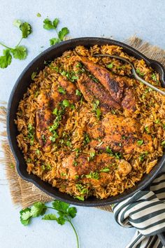 a skillet filled with chicken and rice