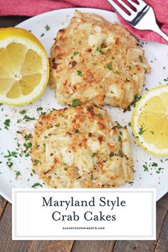 three crab cakes on a white plate with lemons and parsley next to it