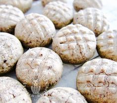 some cookies are covered in powdered sugar and sitting on a counter top next to each other