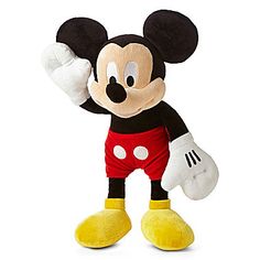 a mickey mouse stuffed animal sitting on top of a white surface