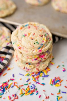 cookies with sprinkles are stacked on top of each other