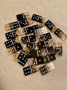 black and white dices with gold dots on them sitting on a carpeted floor