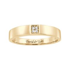 a yellow gold wedding ring with two diamonds on the front and center stone in the middle