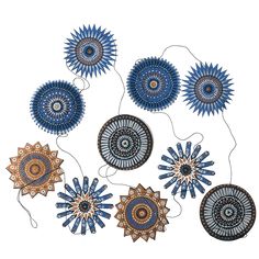 an image of some blue and gold ornaments on a white background with strings attached to it