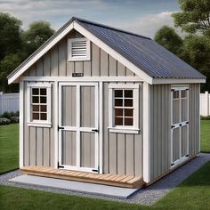 a small shed sitting on top of a lush green field