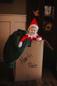 a little boy in a box that says north pole