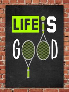 there is a sign that says life is good with two tennis racquets