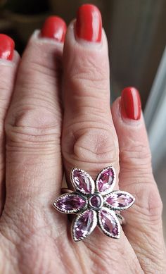 Our 14k white gold pink tourmaline birth flower ring is a birthstone ring & statement ring in one. This is a custom designed ring, which means it is one of a kind design. We love the floral theme in jewelry, as it is the ultimate in femininity, while being fun! Floral jewelry always makes me smile. We used 6 Marquise shaped gemstones for the petals and the center is a 3mm round gemstone. All gems are bezel set for stone security. The metal outlining the petals is given detail by hand. Let us mak Floral Jewelry, All Gems, Custom Ring Designs, Floral Theme, Floral Jewellery, Birth Flower, Birth Flowers, Flower Ring, Birthstone Ring