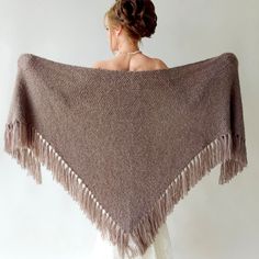 Elevate your style at winter weddings or evening events with the exquisite hand-knitted triangular taupe shawl. This versatile brown wrap piece not only complements any outfit but also provides warmth and protection from the chilly weather throughout fall, winter, and spring. Moreover, these cover up's make an excellent bridesmaid gift. MATERİAL:  Very soft, fuzzy and warm yarn. it is not itchy at all. 10% mohair, 10% wool, 80% premium acrylic-Polyamid,  MEASUREMENTS (Average): Length: 78'' (200 Bridesmaid Cover Up, Winter Wedding Shawl, Fall Winter Wedding, Bridesmaid Shawl, Bridal Cover Up, Bridal Shawl, Bridal Wrap, Wedding Shawl, Winter Weddings