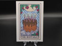 a birthday card with candles on it sitting in front of a black background that says the birthday