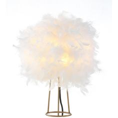 a white feather lamp on a metal stand