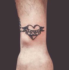 a heart with wings and the word mom tattooed on it