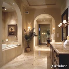 a large bathroom with marble floors and walls