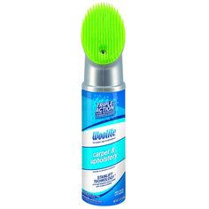 a green brush sitting on top of a bottle of deodorant wipes