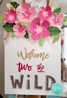 a sign that says welcome two the wild with pink flowers on it and green leaves