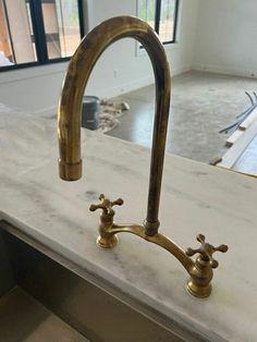 an old faucet sink with two brass faucets on the counter top