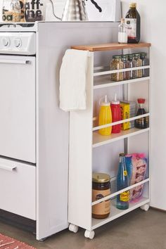 a white stove top oven sitting inside of a kitchen