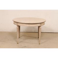 an oval table with two drawers on one end