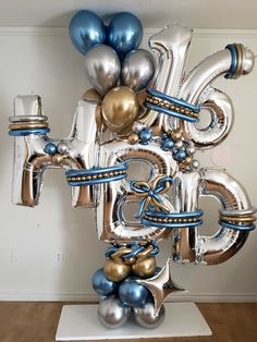 a bunch of silver and gold balloons in the shape of an eiffel tower