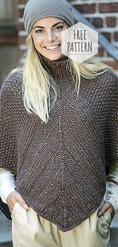 a woman with blonde hair wearing a knitted sweater and beanie smiles at the camera