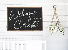 a welcome to my crib sign hanging on the wall next to a white crib