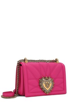 a pink handbag with a heart on the front and chain around the clasps