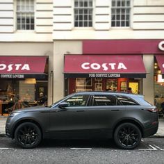 a car is parked in front of costa coffee