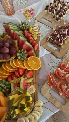 there are many different fruits and vegetables on the trays that have toothpicks sticking out of them