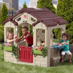 two children playing in a little tikes house