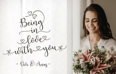 a woman holding a bouquet next to a window with the words being in love with you