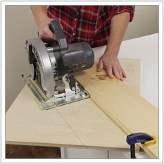 a man is using a circular saw to cut wood planks with a planer