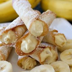 some bananas are stacked on top of each other with powdered sugar in between them