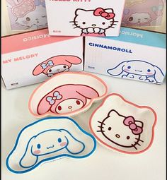 four hello kitty plates with different designs on them