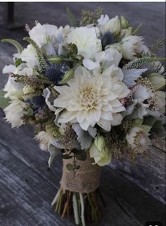 a bouquet of flowers sitting on top of a wooden table