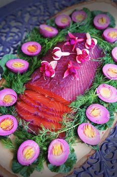 a piece of fish is surrounded by flowers and eggs