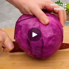 someone is peeling an onion on a cutting board