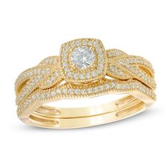 two gold wedding rings with diamonds on each band and an engagement ring in the middle