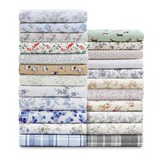 a stack of folded sheets in various colors and patterns, all with flowers on them