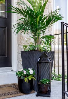 two planters with plants in them on the front porch