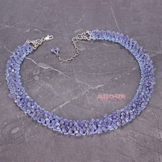 "This beautiful tanzanite necklace was hand-crafted from well polished natural tanzanite crystals with lovely light blue-lavender color. They embroidered netting stitching with Japanese seed beads. Silver colored decorative elements and lobster claw  with extension chain finished this jewelry piece. Tanzanite is the trade name of a mineral named zoisite with a blue color. The name \"tanzanite\" was given because the world's deposit is in northern Tanzania, near the base of Mount Kilimanjaro and city of Arusha. Tanzanite stone is the birthstone for people born in December. This breathtaking gemstone can bring equilibrium to one's life by stimulating different chakras. One of a kind stunning tanzanite necklace is handmade hours and hours of meticulous and precise craftsmanship.      Length i Elegant Sapphire Crystal Necklace With Gemstone Beads, Elegant Tanzanite Gemstone Bead Necklaces, Tanzanite Faceted Beads Jewelry For Gift, Elegant Tanzanite Gemstone Bead Necklace, Elegant Tanzanite Beaded Necklace, Blue Beaded Amethyst Necklace, Elegant Tanzanite Jewelry With Faceted Beads, Tanzanite Beads, Tanzanite Necklace