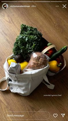 a white bag filled with vegetables on top of a wooden floor