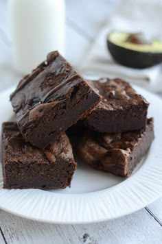 chocolate brownies on a plate with a glass of milk